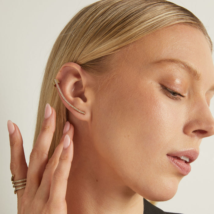 Model Close-up of a woman wearing a diamond ear cuff with a neutral background