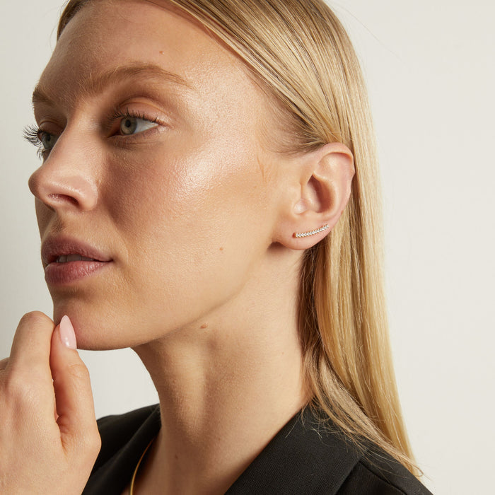 Model Close-up of a woman wearing a diamond earring against a neutral background