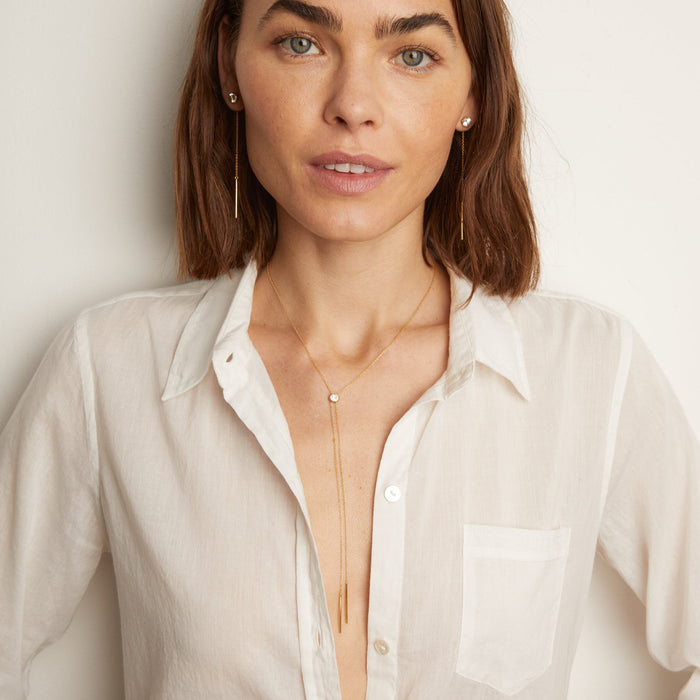 Model. Woman wearing gold bolo necklace