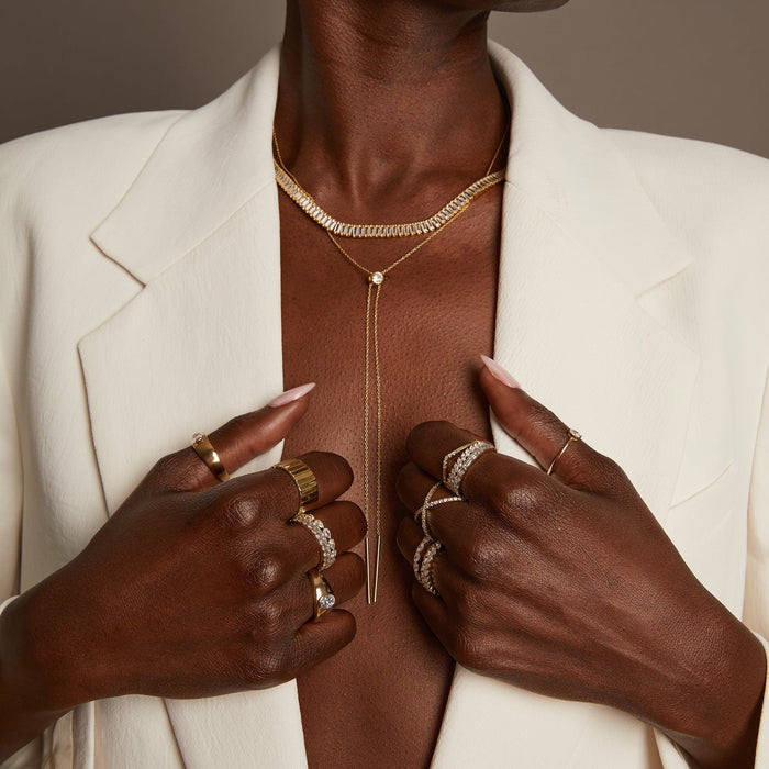 Model. Woman wearing various jewelry and white blazer