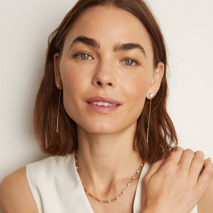 Model. Woman wearing long dangle earrings