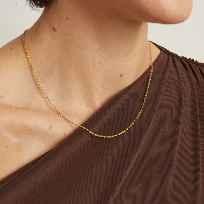 Model. necklace worn by a person with a neutral background