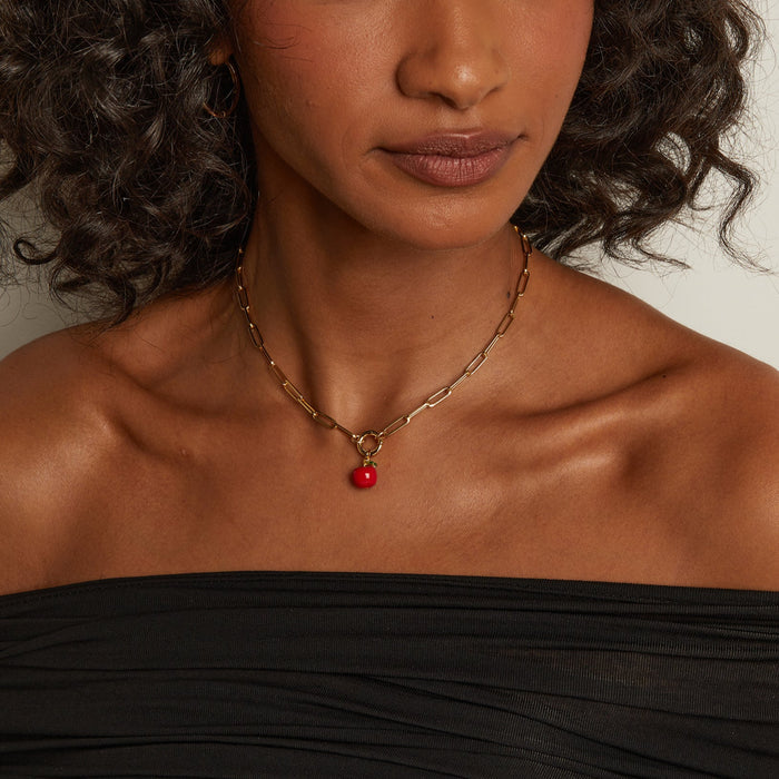 Model. Woman wearing a black off-shoulder top with a neutral background