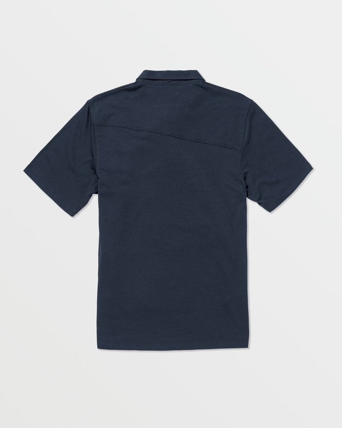 The Volcom Kids' Wowzer Polo Short Sleeve Tee is a navy blue modern fit shirt, shown from the back and laid flat on a white background. Made from a comfortable cotton-poly blend.