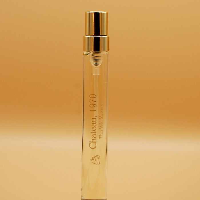 A clear glass 8ml travel sprayer with liquid inside, labeled 'Chateau, 1970'