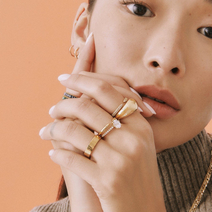 Lifestyle Model woman wearing various gold rings on both hands