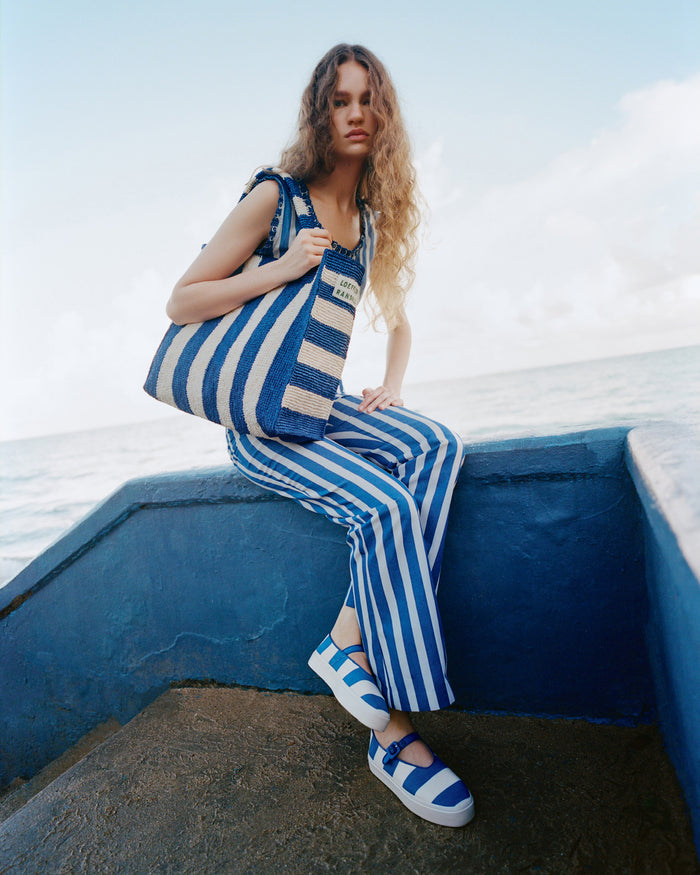 Cooper Blue Striped Mary Jane Sneaker in blue and cream striped canvas, Pasha Trouser in blue and cream striped cotton-linen, Veda Top in blue and cream striped cotton, and Sol Blue Striped Crochet Beach Tote.