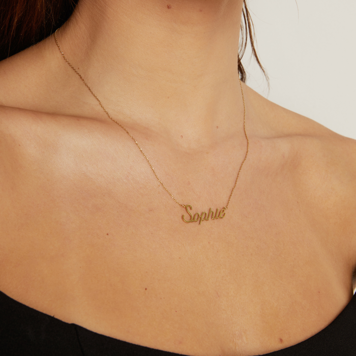 Model The current image shows a close-up of a woman wearing a black top and a delicate gold chain necklace with a script nameplate pendant that reads "Sophie", displayed within the Shopify admin image editor interface.