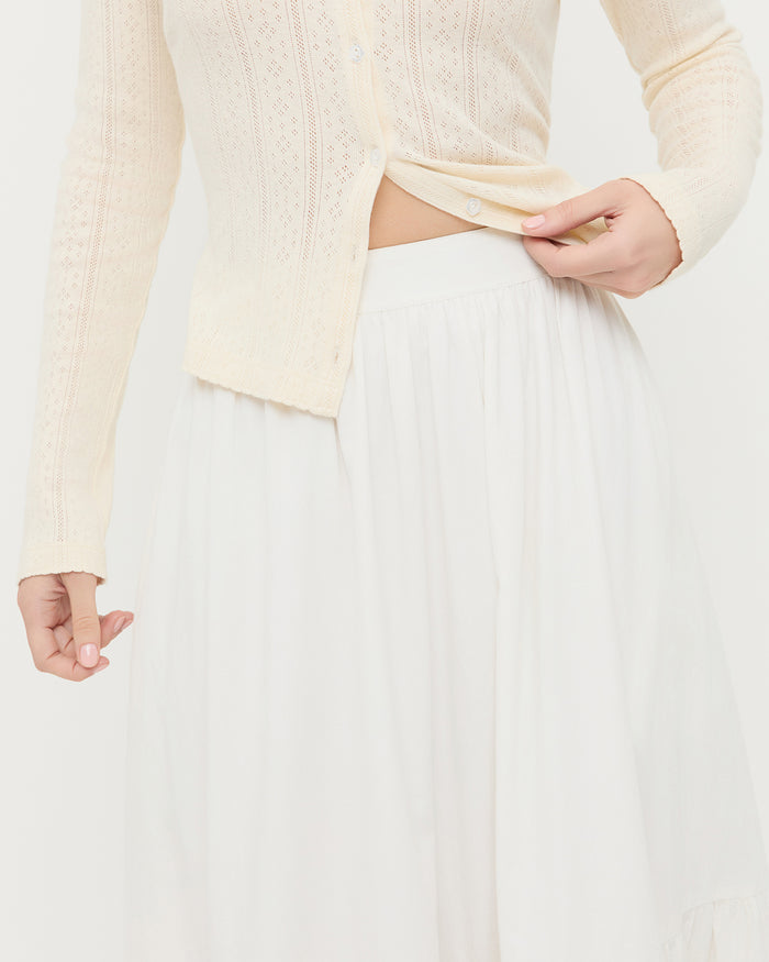 Delaney Midi skirt in cream cotton with lace detailing and Ash Cardigan in cream pointelle cotton.