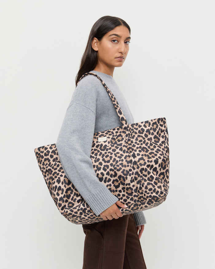 Dina Brown/Leopard Travel Tote in brushed leopard nylon, Lana Cashmere Sweater in grey cashmere, and Molly Workweark Jean in brown denim.