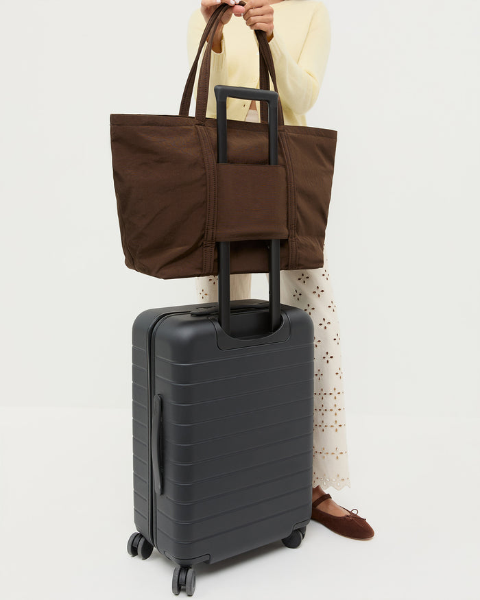 Dina Chocolate Travel Tote in chocolate brown water-resistant nylon, Tucker Cardigan in butter cashmere, and Demi Embroidered Pant in natural cotton.