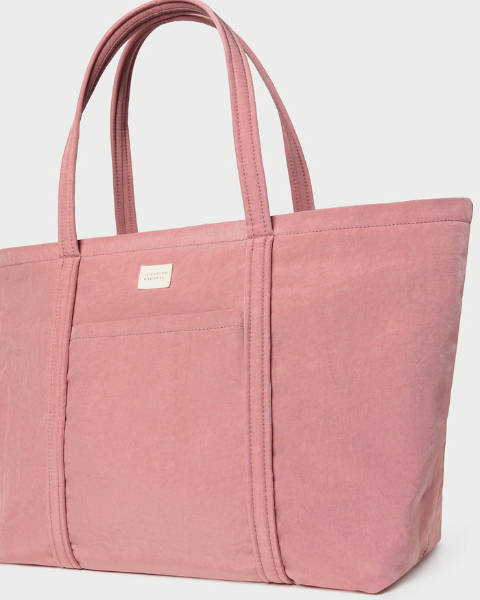 Dina Pink Travel Tote in pink water-resistant nylon.