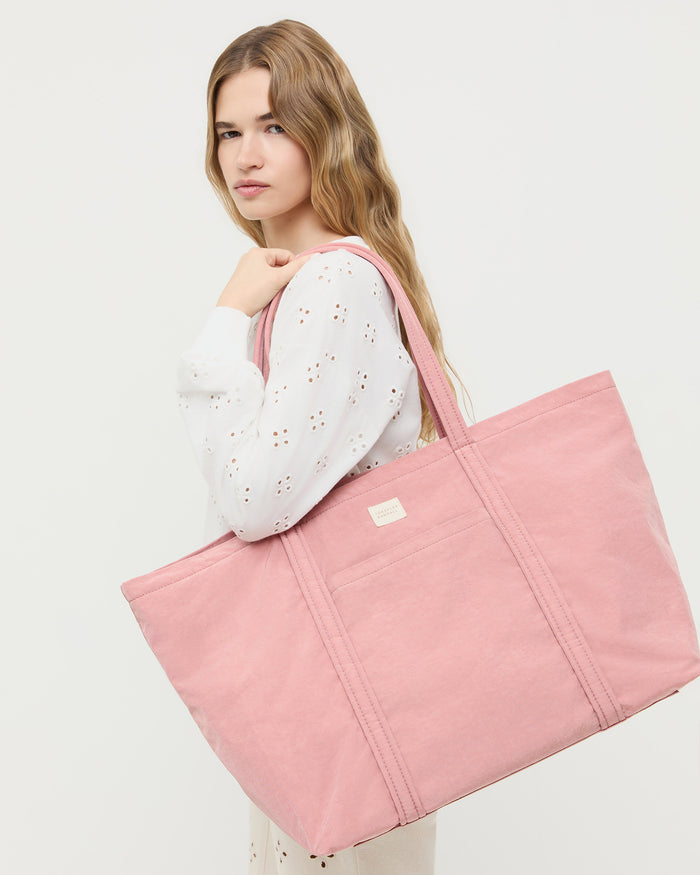 Dina Pink Travel Tote in pink water-resistant nylon.
