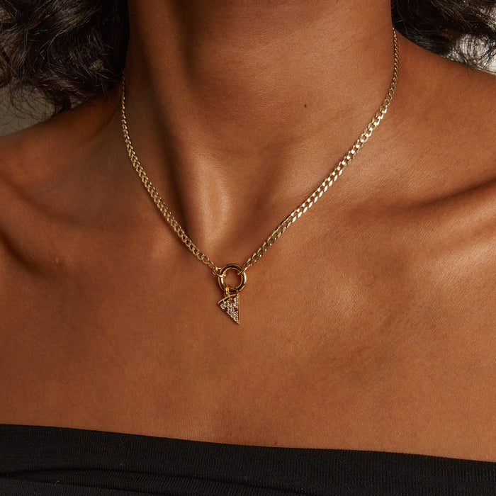 Model. Gold chain necklace with a small pendant on a person's neck