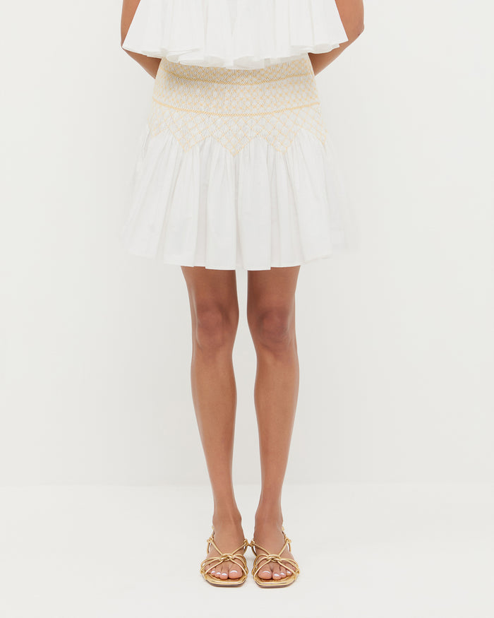 Florrie Mini Skirt in cream cotton, Nola Top in cream cotton, and Karly Gold Leather Strappy Sandal.