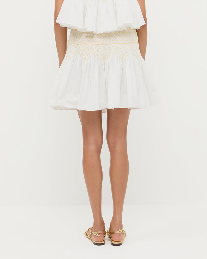 Florrie Mini Skirt in cream cotton, Nola Top in cream cotton, and Karly Gold Leather Strappy Sandal.