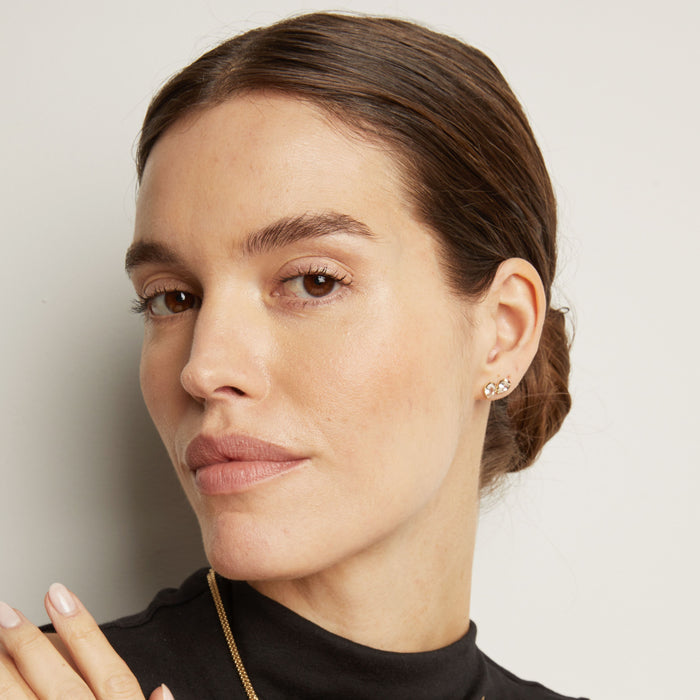 Model. Close-up of a woman with a neutral expression against a plain background