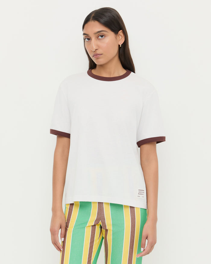 Harly Tee in white cotton with brown accents and Pasha Trouser in green/yellow striped cotton-linen.