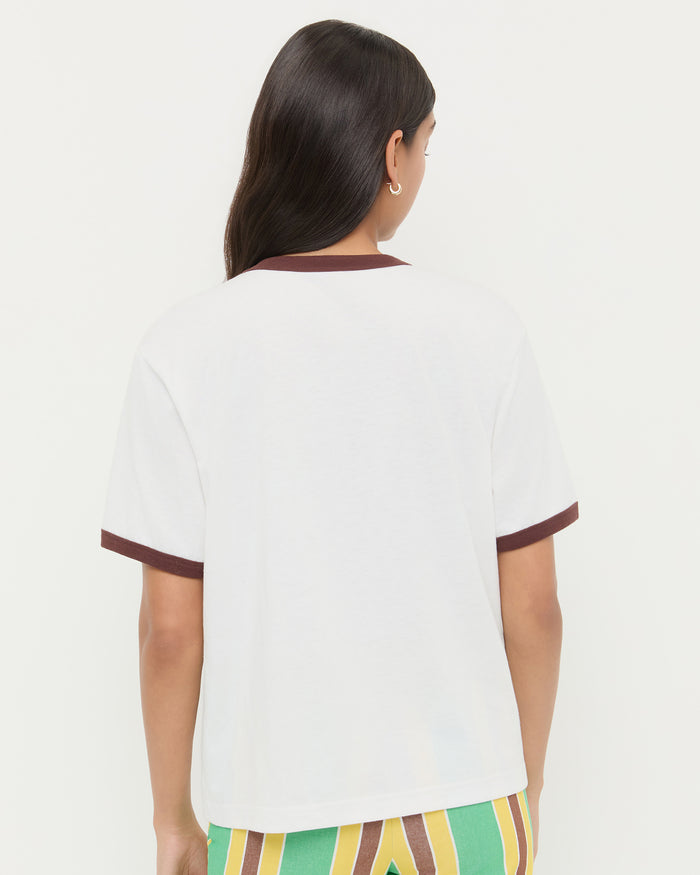 Harly Tee in white cotton with brown accents and Pasha Trouser in green/yellow striped cotton-linen.