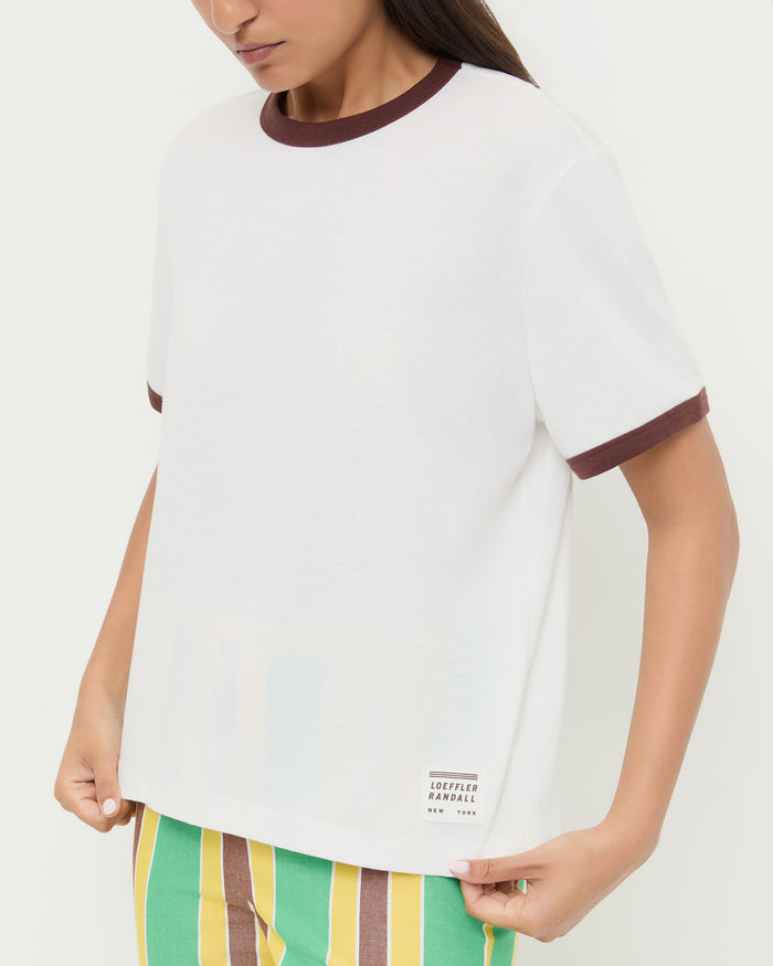 Harly Tee in white cotton with brown accents and Pasha Trouser in green/yellow striped cotton-linen.