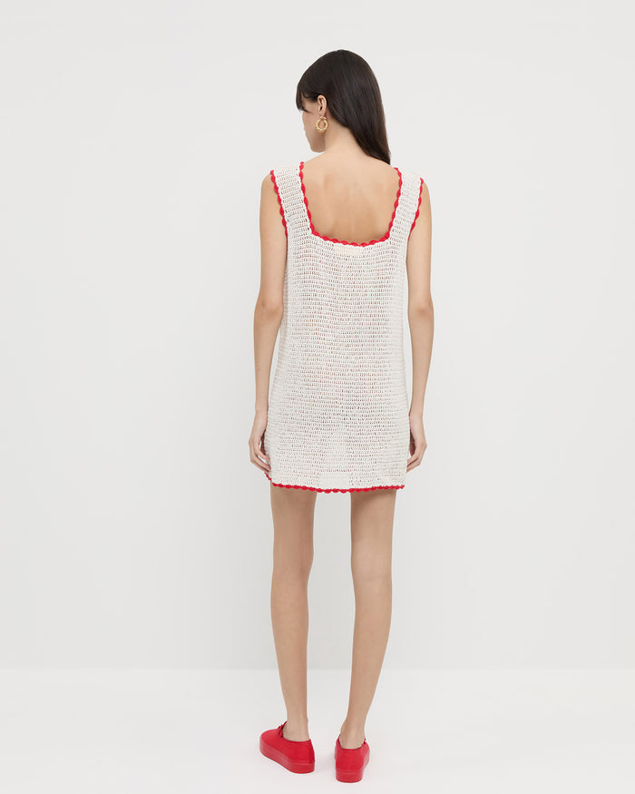 Helena Crochet Dress in cream hand-crocheted cotton with a red flower detail and Cooper Red Mary Jane Sneaker.