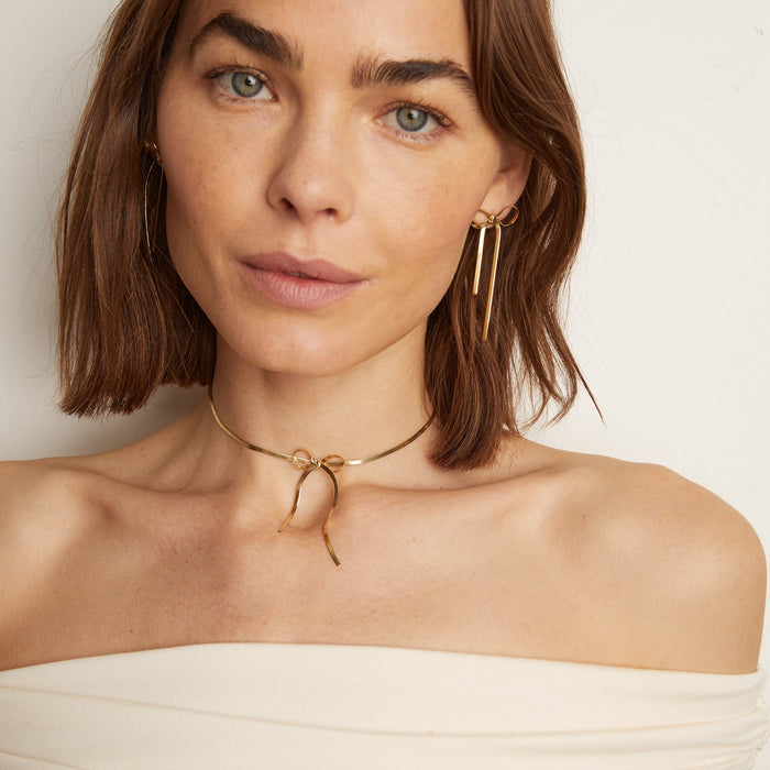 Model.  woman wearing bow necklace