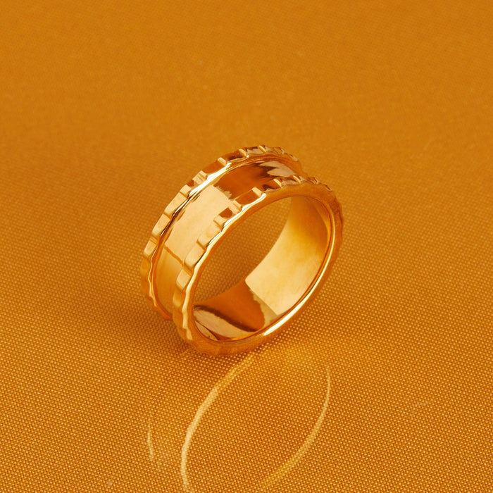Flatlay Model. Thick gold ring on orange background