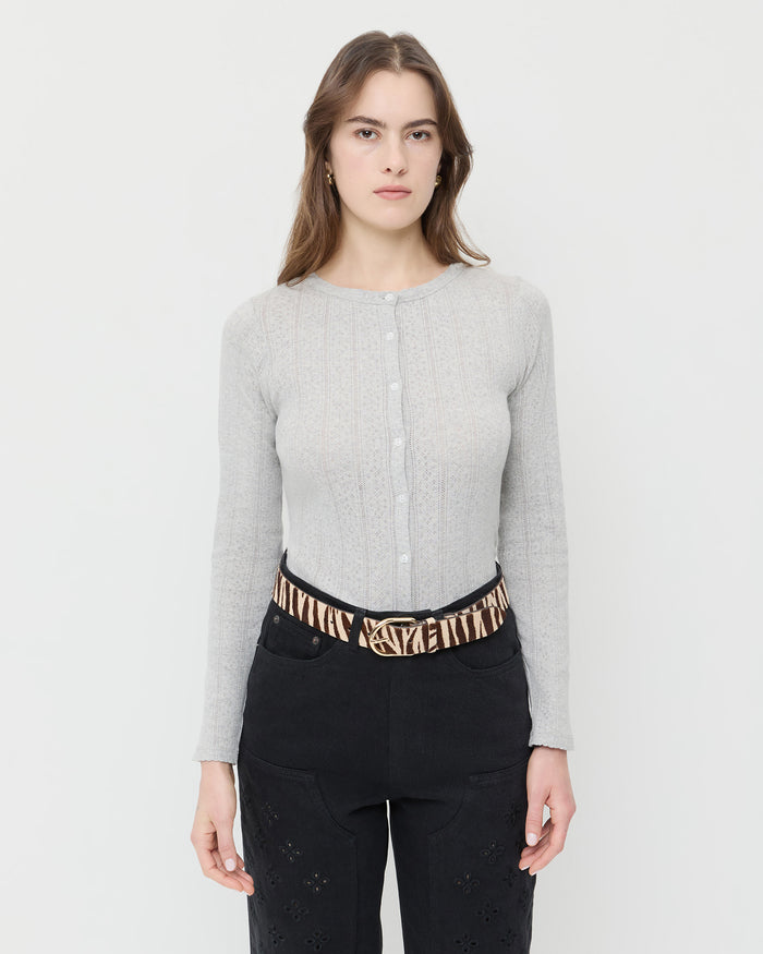 Isaac Cream Zebra Belt in cream zebra print hair calf, Ash Pointelle Cardigan in grey cotton, and Demi Embroidered Pant in black denim.