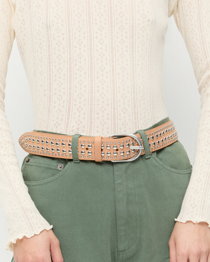Isaac Honey/Silver Studded Belt in honey leather with silver studs, Lolo Long-Sleeve Pointelle Top in cream cotton, and Demi Embroidered Pant in sage green denim.