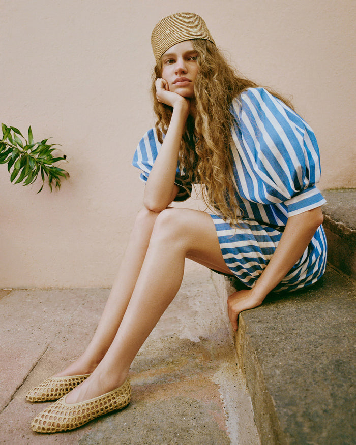 Jackie Natural Hat in natural straw, Willy Mini Dress in blue striped cotton, and Emery Natural Ballet Flat.
