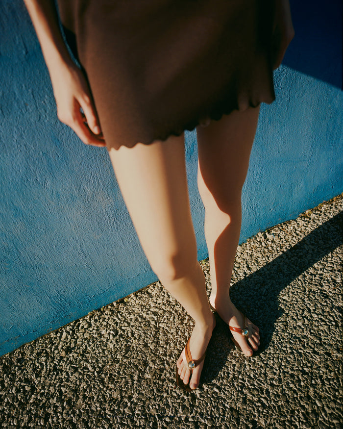 Jovie Brown Jelly Flip Flop in brown jelly with gold accent and Carissa Short in brown linen.