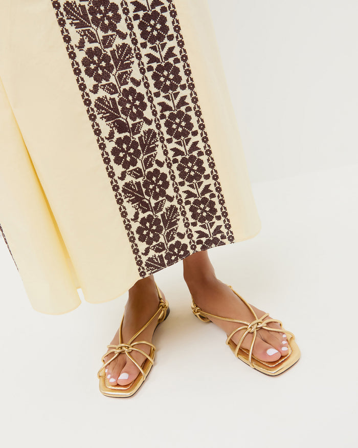 Karly Gold Leather Strappy Sandal in gold metallic leather and Lotus Embroidered Dress in butter yellow and brown embroidery.