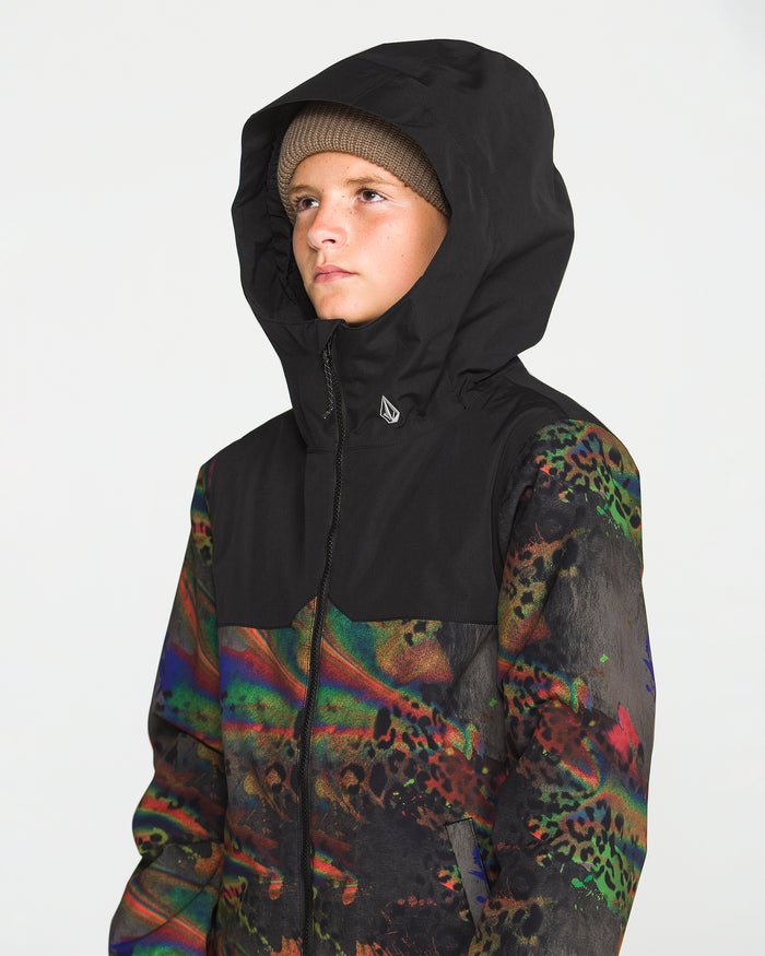 A person wearing a Volcom Kids’ Youth Stone.91 Insulated Jacket in black with colorful abstract sleeve and torso patterns—featuring recycled insulation—and a brown knit beanie underneath, looks off to the side against a plain white background.