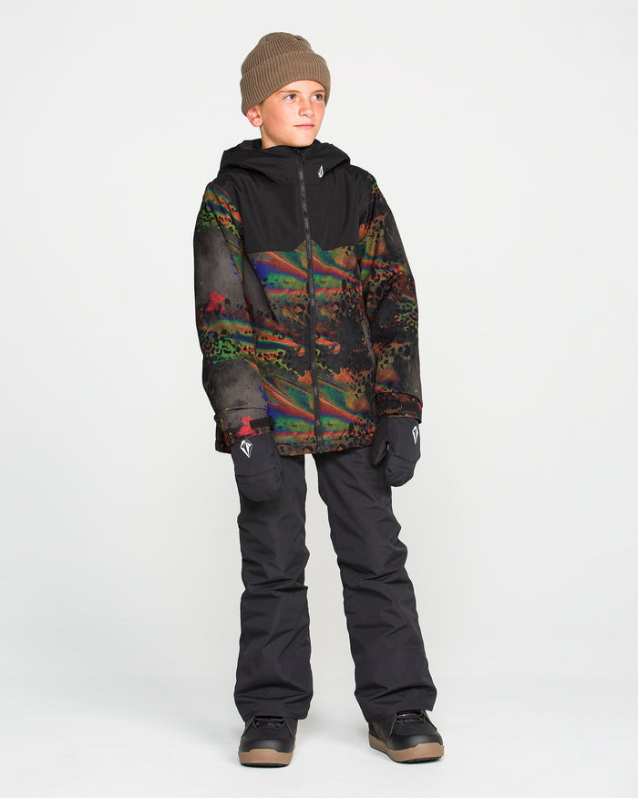 A boy wearing a brown beanie, Volcom Kids’ Youth Stone.91 Insulated Jacket with recycled insulation, black snow pants, black gloves, and boots stands against a plain white background, looking off to the side. The multicolored jacket features Grow-Tech for lasting comfort as he grows.