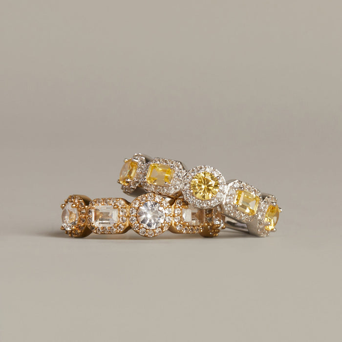 Model. Pair of diamond earrings on a beige background