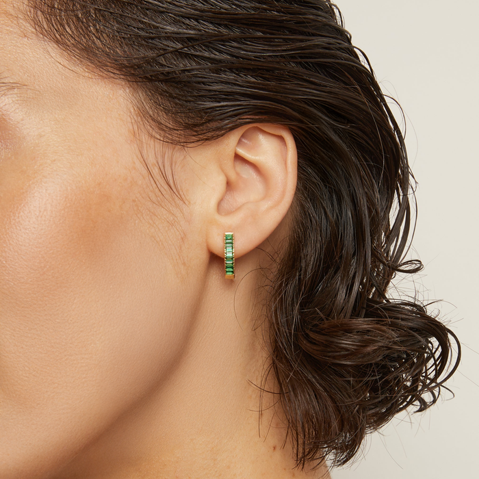 Model. Close up of woman wearing green stone hoop earring