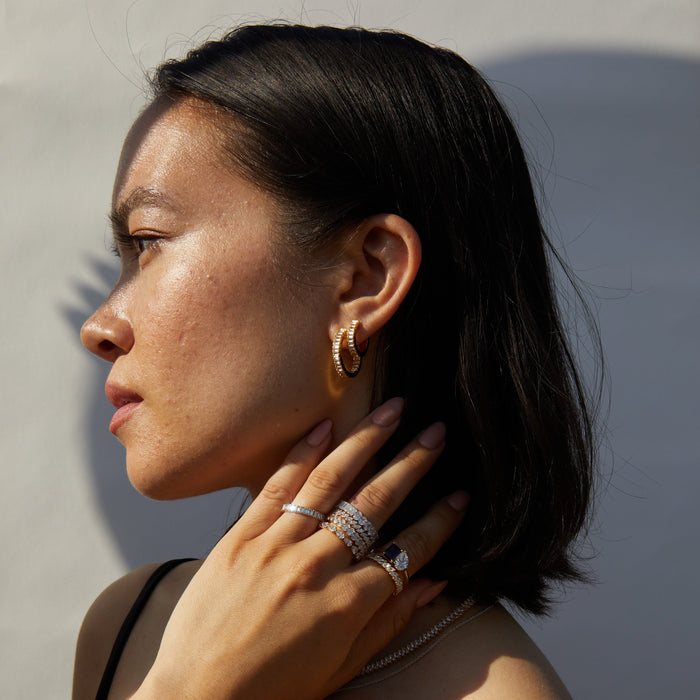 Model.  woman wearing various earrings and rings