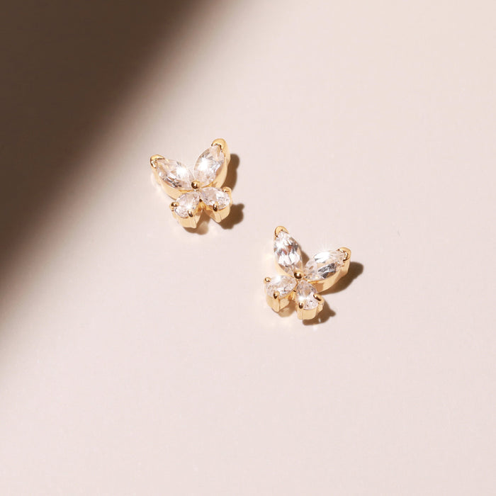 Flatlay Model Two diamond butterfly earrings on a blank background
