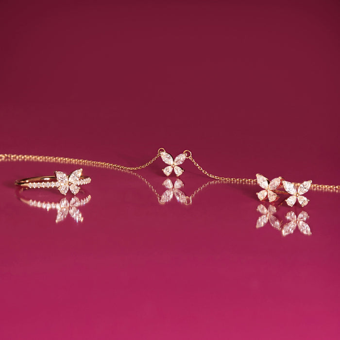 Flatlay Model Butterfly shaped jewelry on a pink background