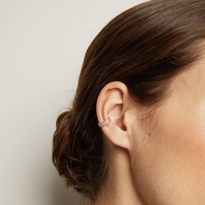 Model. Close up of woman wearing a diamond ear cuff