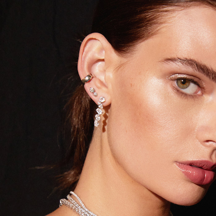 Model. Close up of woman wearing various earrings