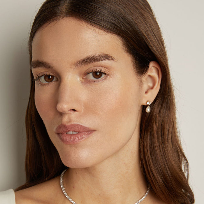 Model. woman wearing pear earring