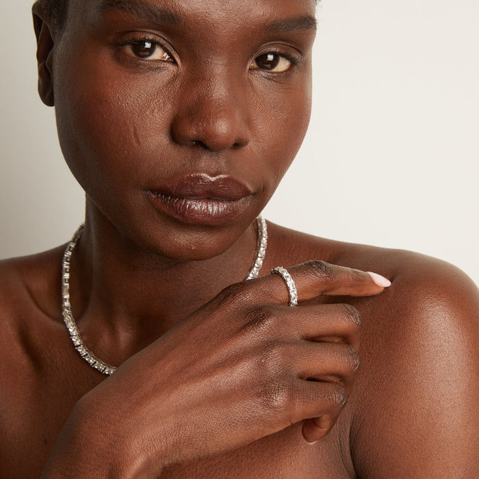 Model woman wearing diamond ring and chains