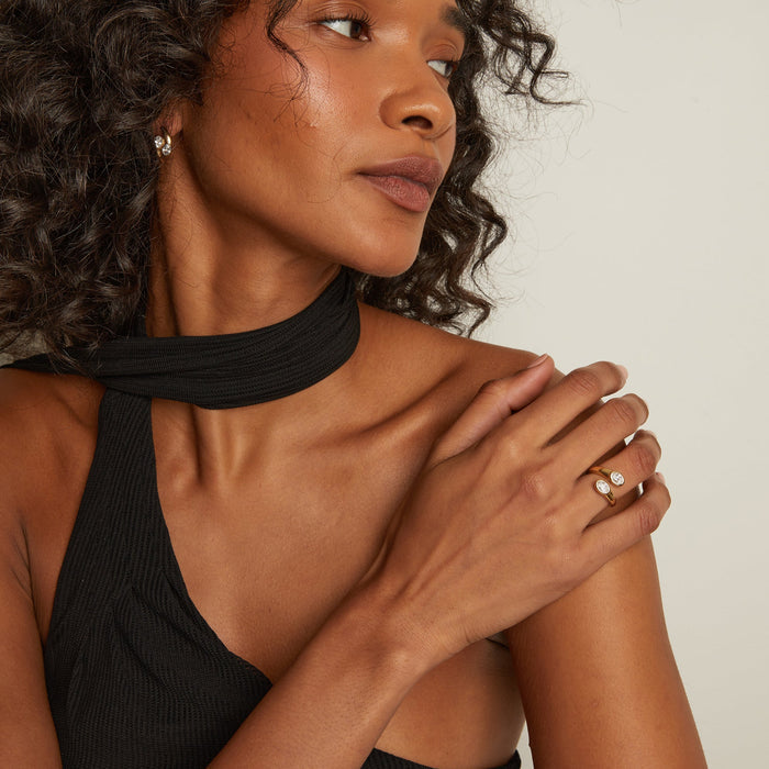 Model. Woman wearing a black halter top with a neutral background