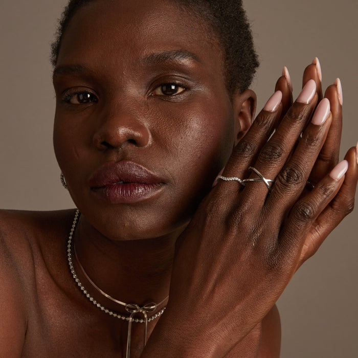 Model Woman wearing various necklaces and rings