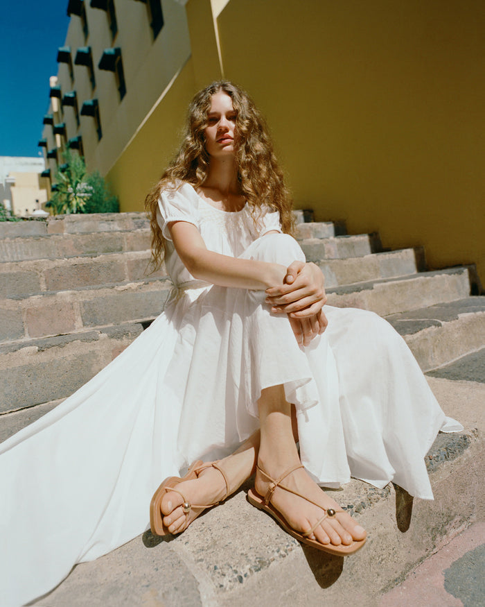 Lara Dune Leather Sandal in dune tan leather with a gold ball accent and Nadya Dress in white cotton.