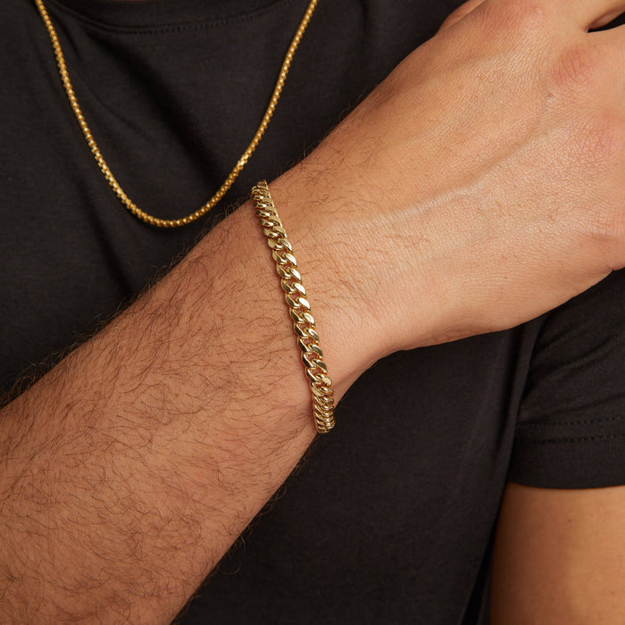 Model. Close up of man wearing gold chain bracelet
