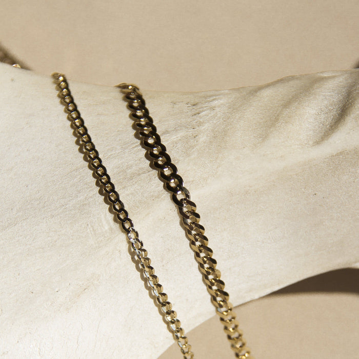 Flatlay Model. Two gold chain necklaces on neutral background