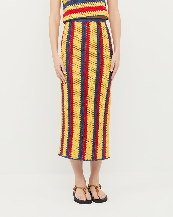 Lela Crochet Skirt in yellow, red, and navy striped hand-crocheted cotton, Prescott Crochet Top in yellow, red, and navy striped hand-crocheted cotton, and Mika Maroon/Yellow Sport Sandal.