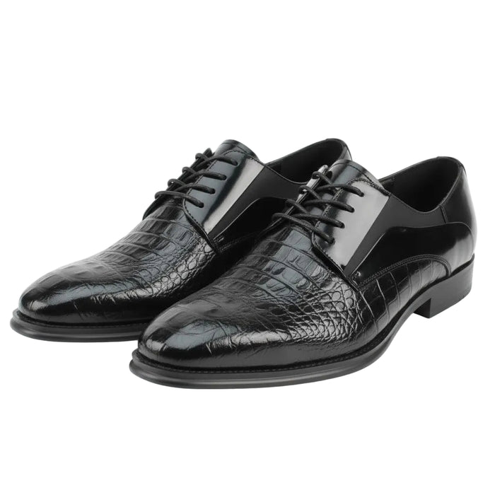 Black dress shoes with crocodile texture on a white background